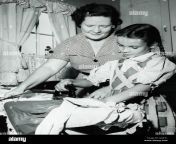 mother instructing young daughter on ironing clothes in 1950 s home akxf31.jpg from xxx 1950 সালেরndian old mom sex video xxxx comwww video xxxx com