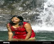 corpulent young indian woman bathing outdoors under waterfall dressed ajp5ng.jpg from indian outdoor