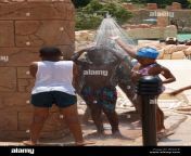 native african children taking bath shower near the pool palace hotel bfxacr.jpg from africa take a bath