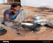 young indian wife in a rural village making chapati on an open fire cb3cwj.jpg from villag wife