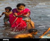 indian mother bathing his son on the waters of tungabhadra river hampi cefypc.jpg from mother and son in bath tub