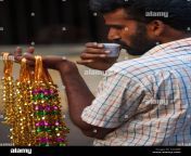 rear view of seller of necklaces drinking in a plastic cup chennai cxxxbf.jpg from tamil cxxx
