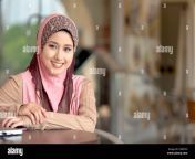young pretty asian muslim woman in head scarf smiles while waiting c3wthh.jpg from malay