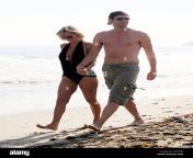 jenny mccarthy and jim carrey take a stroll on the beach before returning c0h9np.jpg from malibu ca actress jenny mccarthy and her long time boyfriend actor jim carrey spend the 4th of july with jennys son evan in their malibu home the couple looked happier than ever stealing kisses in between talking jenny spent great deal of time playing on the beach with evan building sandcastles and playing in the sand while jim watched on from their porch jim carrey was sporting peppered beard making him look older than usual which he didnt seem to mind gsi media july 2009 2a0cbkm jpg