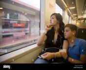 10 and 18 year old brother and sister in commuter train using ipod def5gy.jpg from brother vs sister 18 old