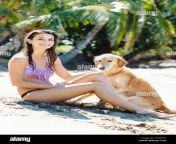 attractive young woman enjoying sunny day at the beach with her dog dxw522.jpg from beautiful xxxdog