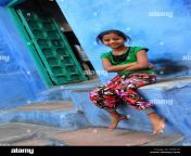 young indian girl in front of her home blue washed buildings are typical ef4e1e.jpg from desi small garil an
