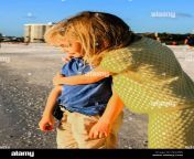 young pre teen sister giving her younger brother a hug on siesta key f822bn.jpg from cute sister gives brother