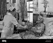 1970s nhs charing cross hospital london nurse giving patient a cup kpfd5c.jpg from www saxs video hospetl