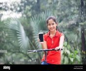 young girl showing mobile phone park smiling kx35wb.jpg from village park indian call sex xh